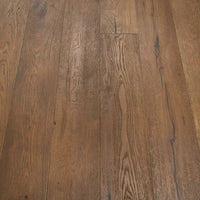 Medium brown hardwood flooring planks with visible natural grain patterns and knots.