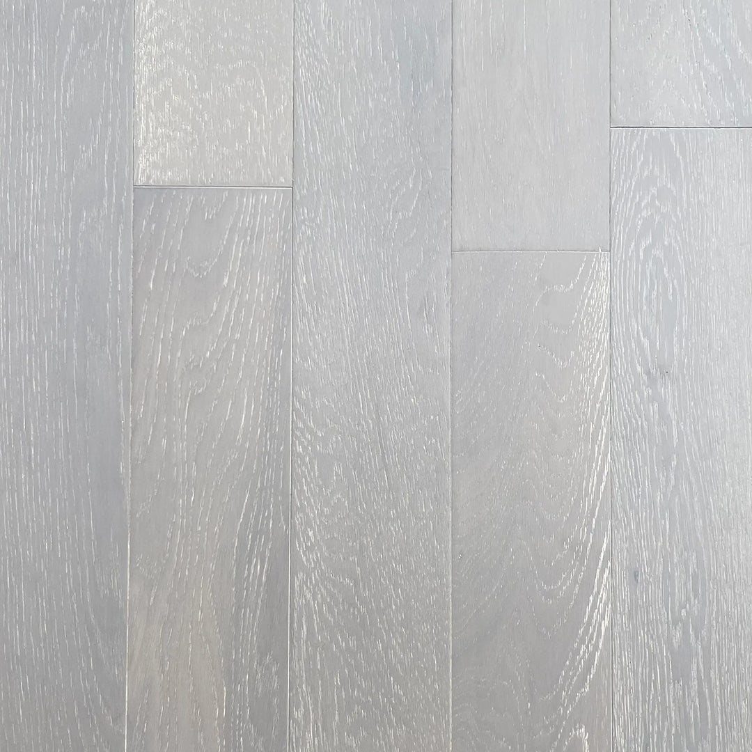 Light gray wood-look plank flooring with visible natural grain patterns and subtle tonal variation across the planks.