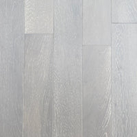 Light gray wood-look plank flooring with visible natural grain patterns and subtle tonal variation across the planks.