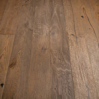 Medium brown hardwood flooring planks with visible natural grain patterns and knots.