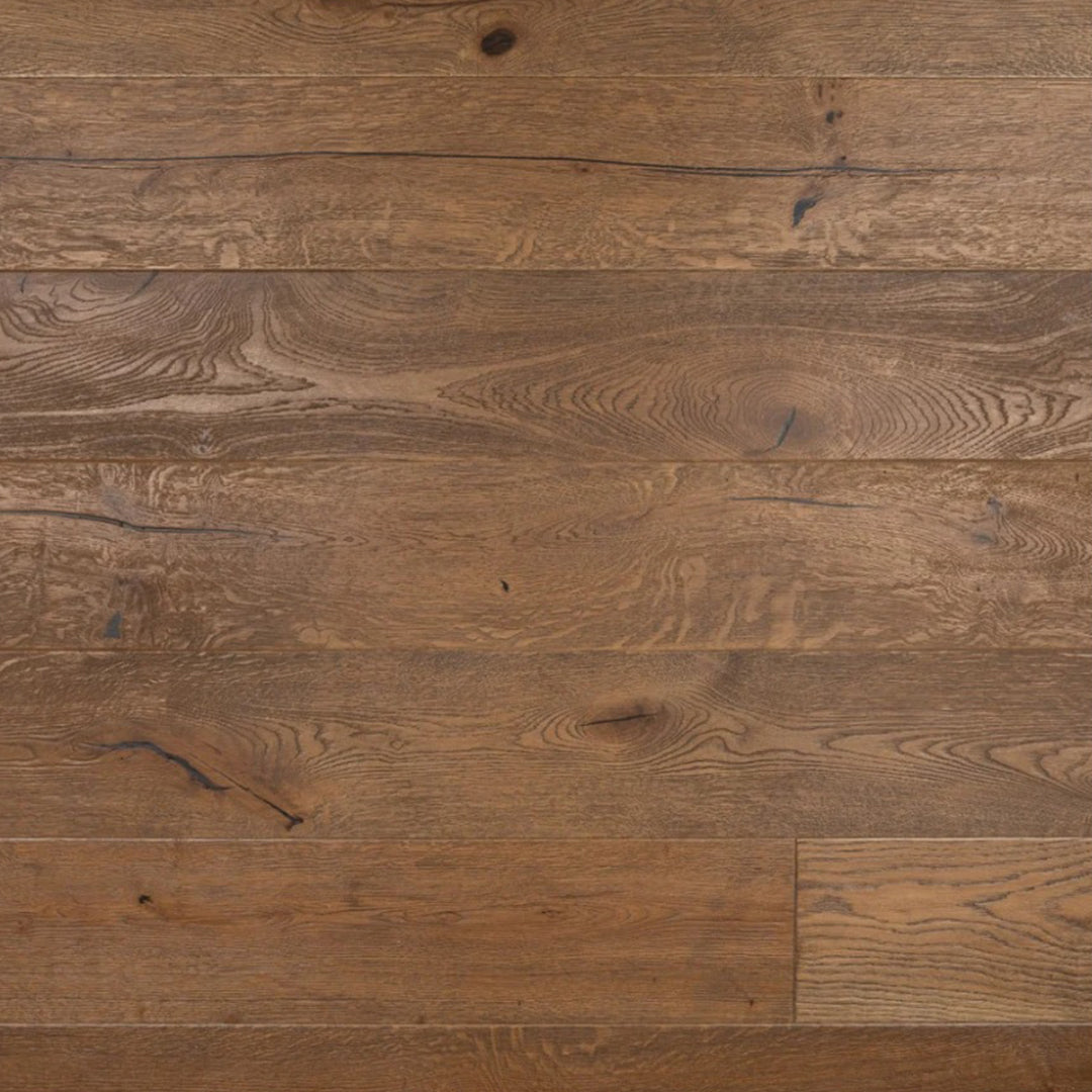 Medium brown hardwood flooring planks with visible natural grain, knots, and wood texture.