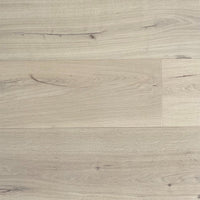 Light oak wood flooring planks with visible grain, knots, and natural texture in a pale beige-gray tone.