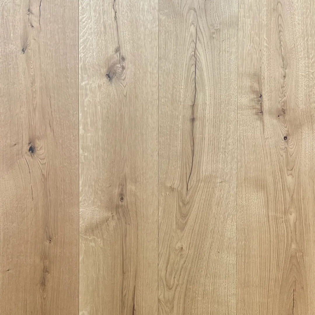 Light natural wood plank flooring with visible grain patterns and knots in warm beige and tan tones.