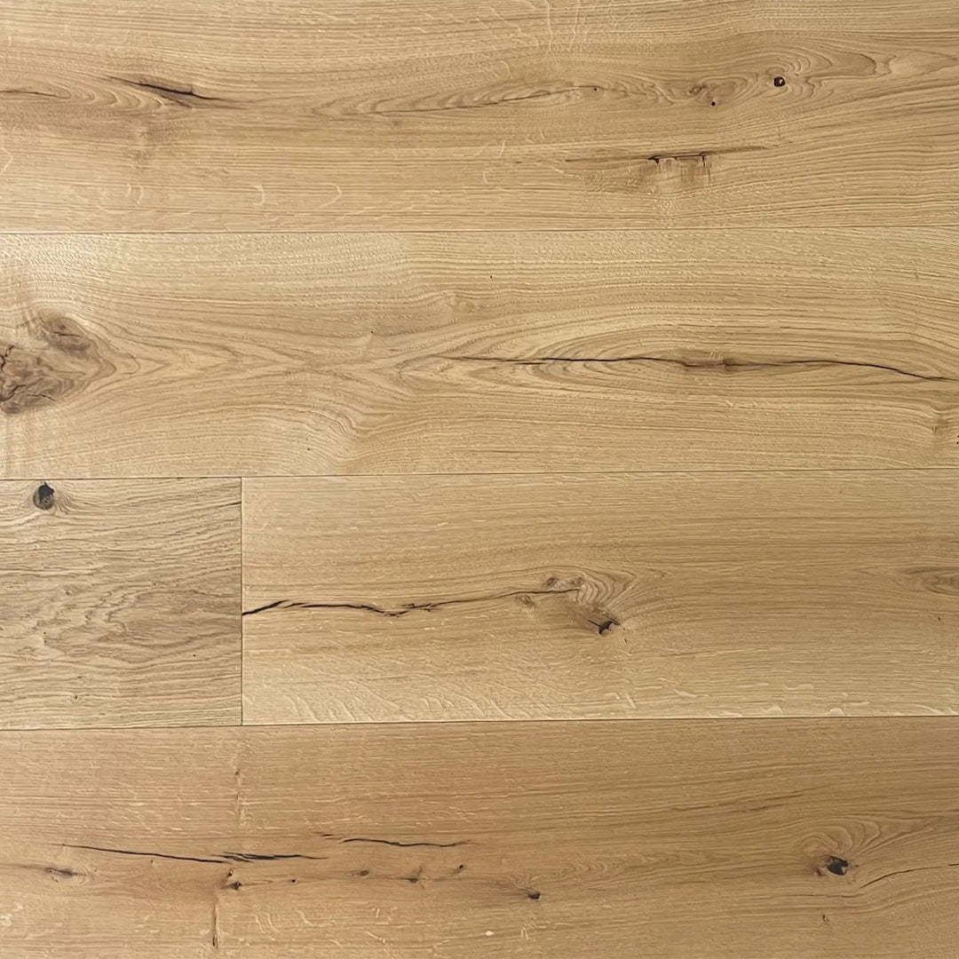 Light oak wood flooring planks with visible grain, knots, and natural wood textures.