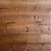 A close-up view of rustic medium-brown wood planks with visible grain, knots, and natural texture.