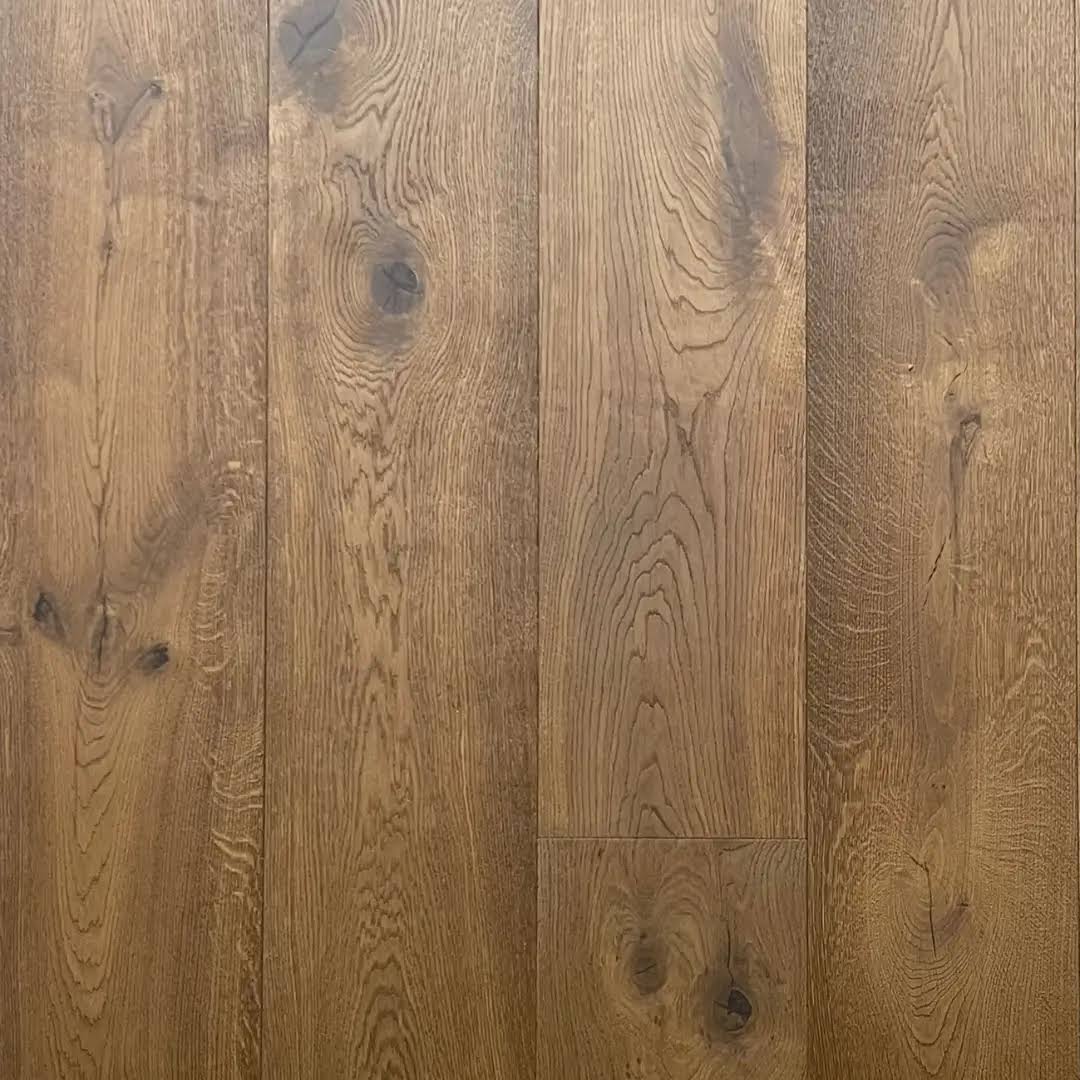 Medium brown wood flooring planks with visible grain patterns and dark knots.