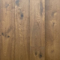 Medium brown wood flooring planks with visible grain patterns and dark knots.