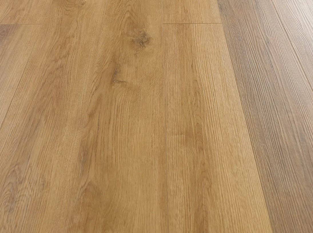 Light oak wood flooring planks with visible grain, knots, and a warm golden-brown tone.