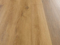 Light oak wood flooring planks with visible grain, knots, and a warm golden-brown tone.