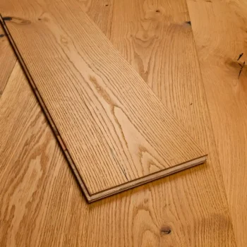 Close-up of a single natural oak plank showing brushed and oiled texture and subtle grain detail