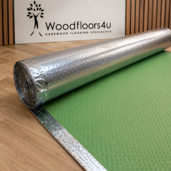 Roll of Baseline SL perforated underlay for underfloor heating systems, showing silver foil backing and green foam upper surface, suitable for use with wood flooring
