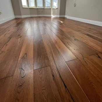 Antique double smoked oak flooring fully installed in a room, showing natural character