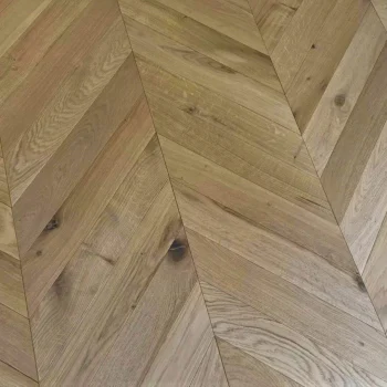 Close-up of Chevron Natural Oak Matt Lacquered Flooring with refined grain texture and smooth luxury finish