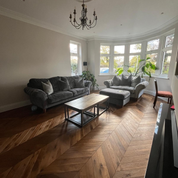 Luxury double smoked chevron oak flooring installed in a living room with brushed and oiled finish