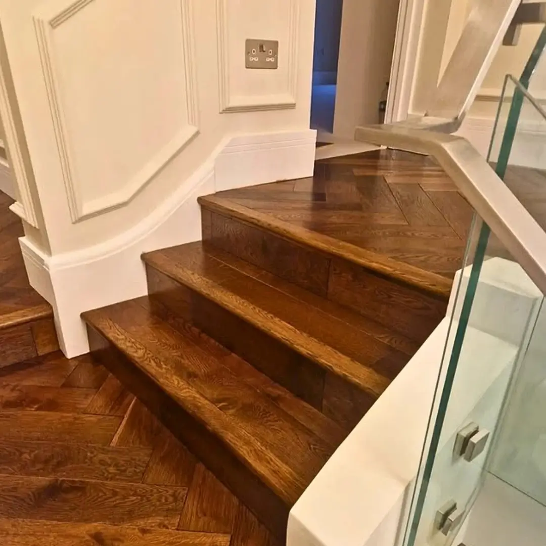 Angled view of finished solid oak stair bull nosing on stairs