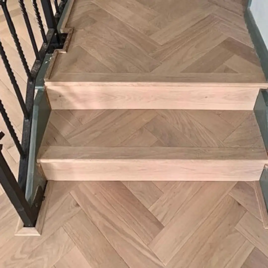 Solid oak stair bull nosing installed on wooden stairs