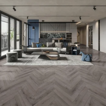 New Deluxe Laminate Carbon Grey Oak Herringbone installed in a modern room – 12 x 101 x 606mm