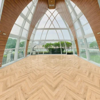 Installed Invisible Oak herringbone laminate flooring showing the 12mm Deluxe Laminate pattern in a light natural oak shade.